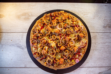 seafood pizza with salmon and caramelized blue onion