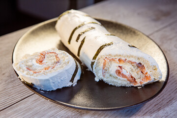 sponge roll with red fish decorated with birch