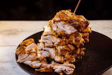 sliced baked meat on a wooden spit