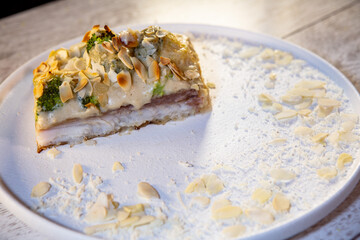 white fish with bechamel sauce and almond petals