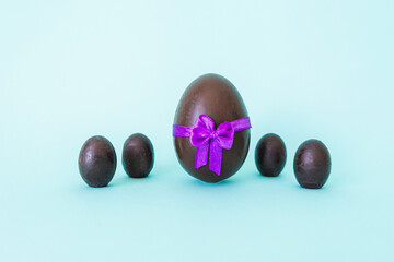 Chocolate eggs on a blue background with space for text. High quality photo
