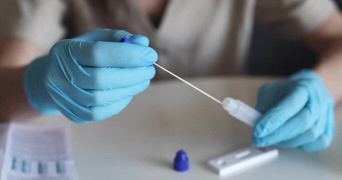 Process of express fast coronavirus covid Antigen AG PCR testing examination at home, COVID-19 swab collection kit, test tube for taking OP NP patient specimen sample, testing carried out

