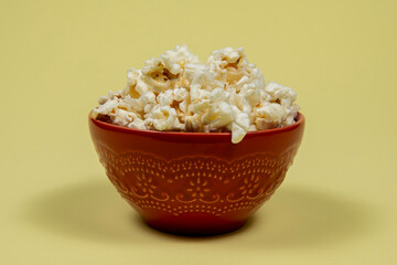 A ceramic bowl of salted popcorn