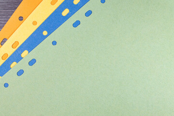 Background from sheets of colored office covers, close-up, top view, space for text, copy space.