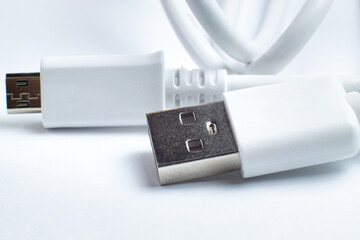USB cable lugs date or charging for phone closeup on white, space for text.