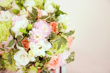 Round bouquet with white freesia flower, green dianthus, peach roses, light chrysanthemum and fresh...