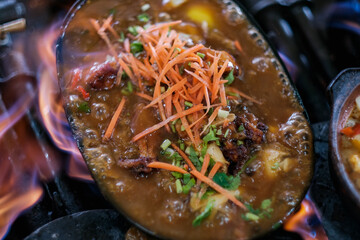 Clay Pot "Mee Kari " or curry noodles with flavorful cooked Ingredients. Usually eat with fishball and fishcake. Image is a selective focus