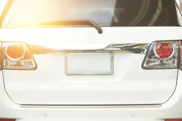 Rear aspect or back view of SUV car in day time on road