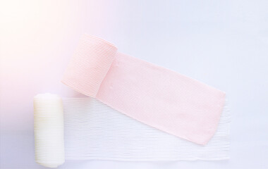 Roll elastic bandage and gauze on white background