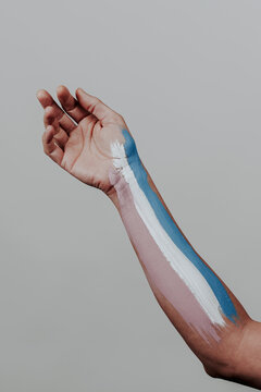 transgender pride flag in the arm of a person