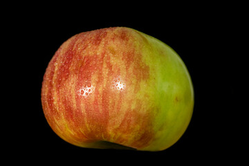 apple with drop of water isolated on black background