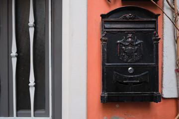 old mailbox on the wall near the door. vintage postbox. send mail concept