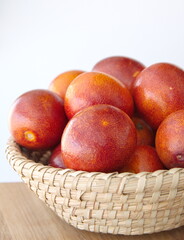 Basket with  Italian Blood oranges,   Citrus sinensis,  Sweet red Orange,  on white background