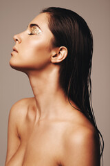 Showing off her inner shine. Studio shot of a glamorous young woman with closed eyes wearing gold...
