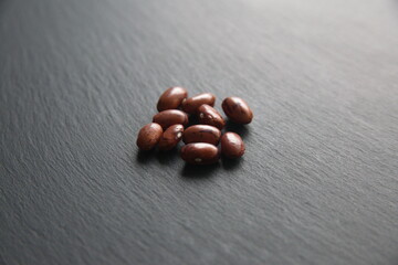 Phaseolus vulgaris, common bean (bush beans, dwarf beans,  pole bean, climbing beans)- herbaceous annual plant, legume family Fabaceae, edible seeds on grey stone background