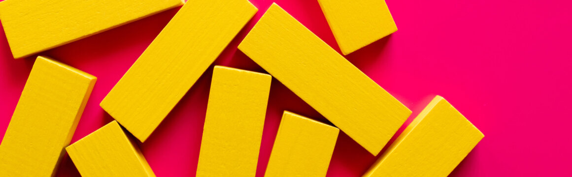 top view of yellow rectangular blocks on pink background, banner.