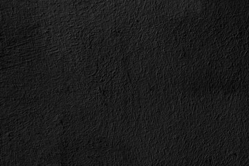 Black grungy wall plaster texture.