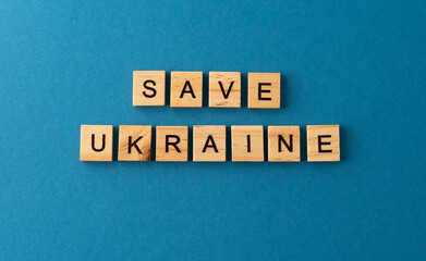 Save Ukraine background. Phrase from wooden letters. Top view words. The phrases is laid out in wood letter. Motivation.