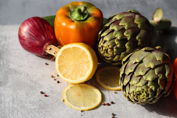 Still life with fresh organic artichokes on a table. Close up photo of seasonal vegetables. Eating fresh concept. 