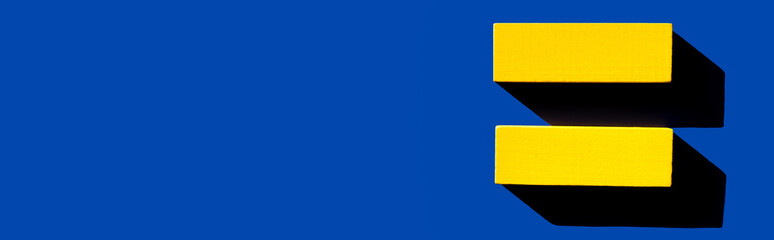top view of yellow horizontal blocks on blue background, ukrainian concept, banner.