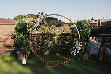 Coziness and style. Modern event design. Lounge zone and european traditional wedding ceremony decoration outdoors in the restaurant before the reception.