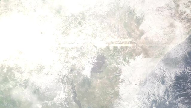 Earth zoom in from outer space to city. Zooming on Mukono, Uganda. The animation continues by zoom out through clouds and atmosphere into space. Images from NASA