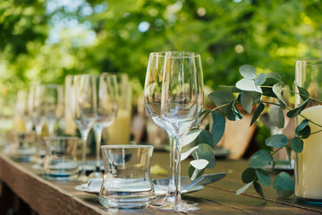 Close Up of table setting for holiday. Wooden wedding table with cutlery and candles, decorations...
