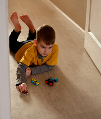boy playing with car on the floor