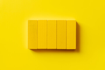 top view of colored rectangular blocks on yellow background.