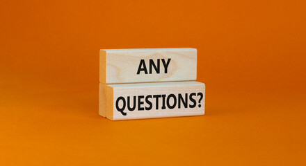 Any questions symbol. Concept words Any questions on wooden blocks on a beautiful orange table orange background. Business and Any questions Q and A concept, copy space.