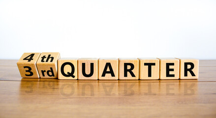From 3rd third to 4th forth quarter symbol. Turned wooden cubes and changed words 3rd quarter to 4th quarter. Beautiful wooden table white background. Business happy 4th quarter concept. Copy space.
