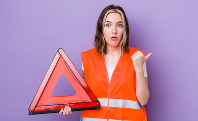 pretty caucasian woman looking astonished in disbelief. car triangle concept