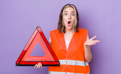 pretty caucasian woman amazed, shocked and astonished with an unbelievable surprise. car triangle...