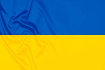 Smooth elegant tissue abstract background in color of ukrainian flag. Textile background. Cloth wallpaper. Graphics design element