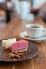 Slices of cake served with almonds and coffee