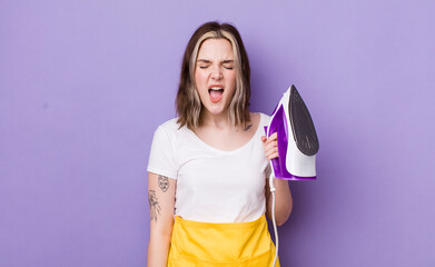 pretty caucasian woman shouting aggressively, looking very angry. hand iron concept