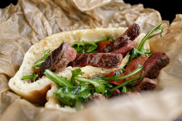 Gyros, shawarma with meat and herbs, on paper