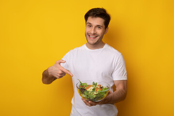 Portrait of Smiling Guy Holding Bowl With Salad