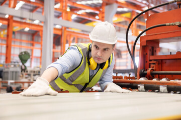 Caucasian Worker Checking on the Metal Sheet From the Machine