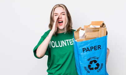 pretty caucasian woman feeling happy,giving a big shout out with hands next to mouth. ecology...