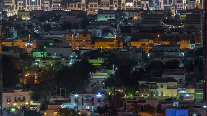 Fototapeta na wymiar Aerial view of apartment houses and villas in Dubai city night timelapse, United Arab Emirates