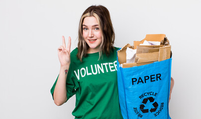 pretty caucasian woman smiling and looking friendly, showing number two. ecology concept