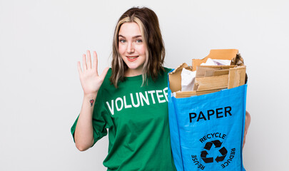 pretty caucasian woman smiling and looking friendly, showing number five. ecology concept