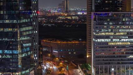 Skyline view of traffic on Al Saada street near financial district night timelapse in Dubai, UAE.