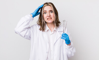 pretty caucasian woman feeling stressed, anxious or scared, with hands on head. dentist concept