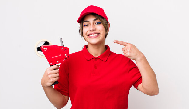pretty hispanic woman smiling confidently pointing to own broad smile. packer concept