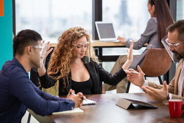 Businesswoman in face shield explaining work project to colleagues in the office. group of business financial discussing project. Corporate team brainstorming and sharing idea. 
