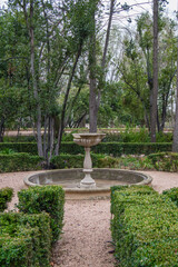 Fototapeta na wymiar garden with stone fountain in the historic gardens of the fincaa de Vista Alegre in Madrid