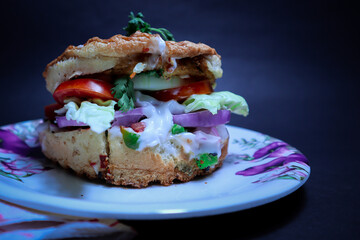 Delicious Burger with green fresh vegetable and mayonnaise and cheese.
