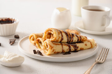 Thin pancakes with sour cream and chocolate topping. Shrovetide. Traditional russian breakfast....